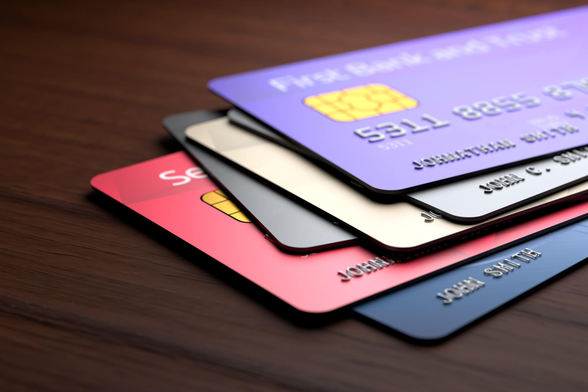 Close-up of a stack of credit cards, arranged neatly with different designs visible on the front.